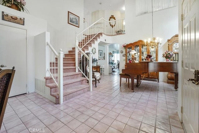 1308 Pleasant Valley Ave, Banning, CA 92220 - entryway with a chandelier, arched walkways, light tile patterned flooring, a high ceiling, and stairway