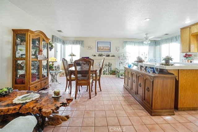 1308 Pleasant Valley Ave, Banning, CA 92220 - dining room with light tile patterned floors, visible vents, a textured ceiling, and a wealth of natural light