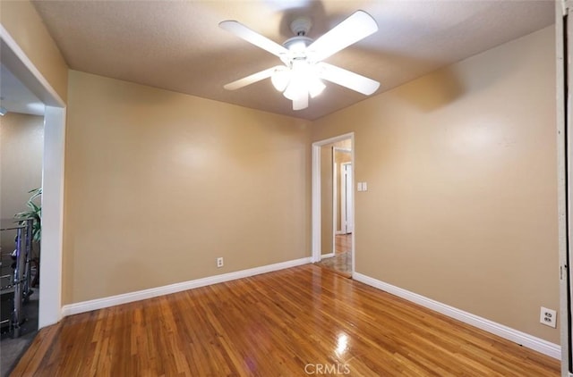 spare room with ceiling fan and hardwood / wood-style floors