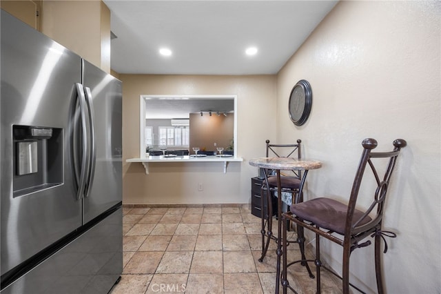 kitchen with stainless steel fridge with ice dispenser and kitchen peninsula