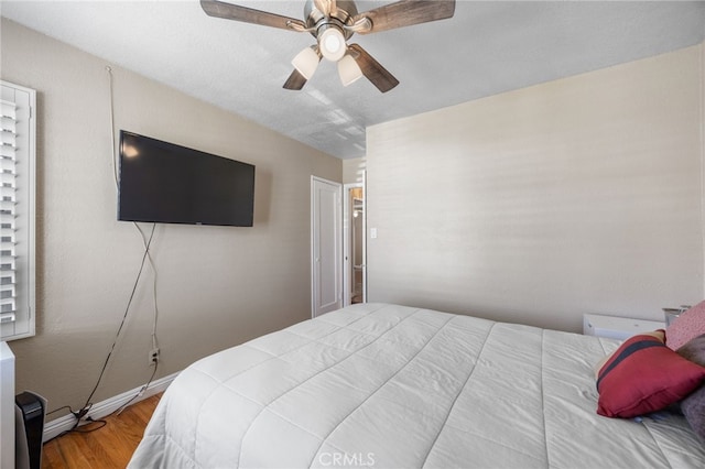 bedroom featuring hardwood / wood-style flooring and ceiling fan