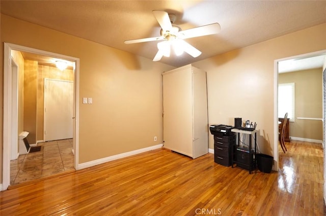 interior space featuring light hardwood / wood-style floors and ceiling fan