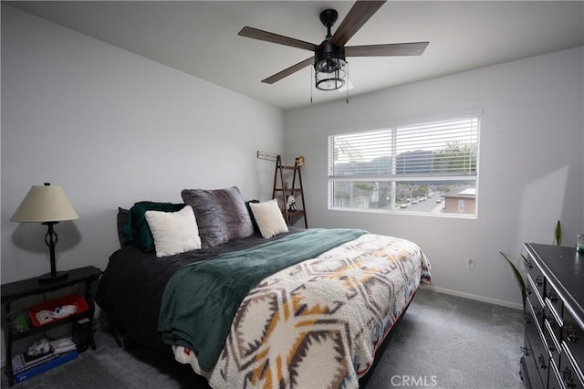 bedroom with ceiling fan and dark carpet