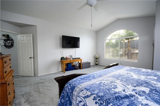 carpeted bedroom with vaulted ceiling and ceiling fan