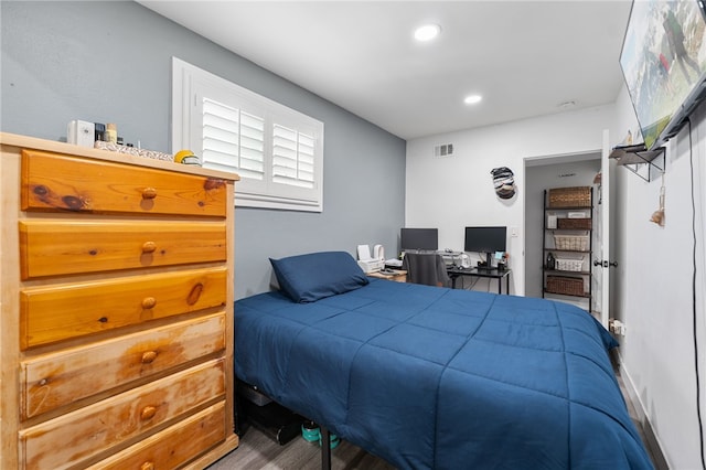 bedroom with recessed lighting, visible vents, and wood finished floors