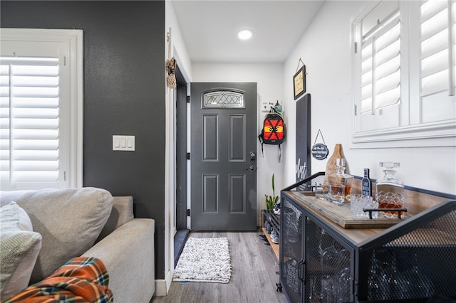 entrance foyer with recessed lighting, baseboards, and wood finished floors