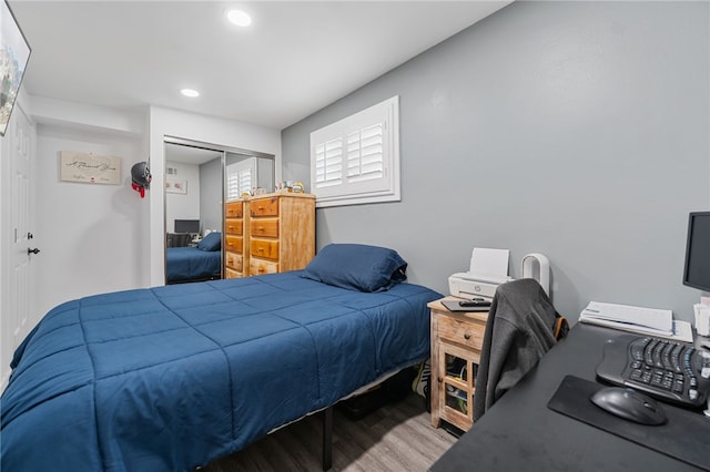 bedroom featuring a closet, recessed lighting, and wood finished floors