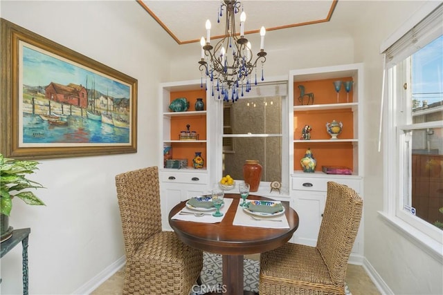 dining area featuring built in features and a notable chandelier