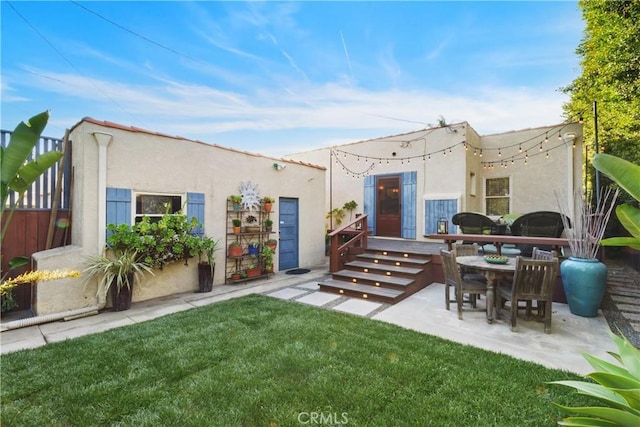 rear view of property with a yard and a patio area