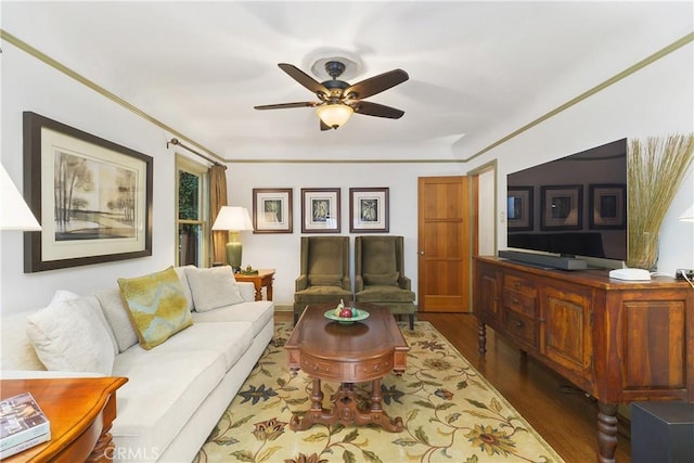 living room with crown molding, dark hardwood / wood-style floors, and ceiling fan