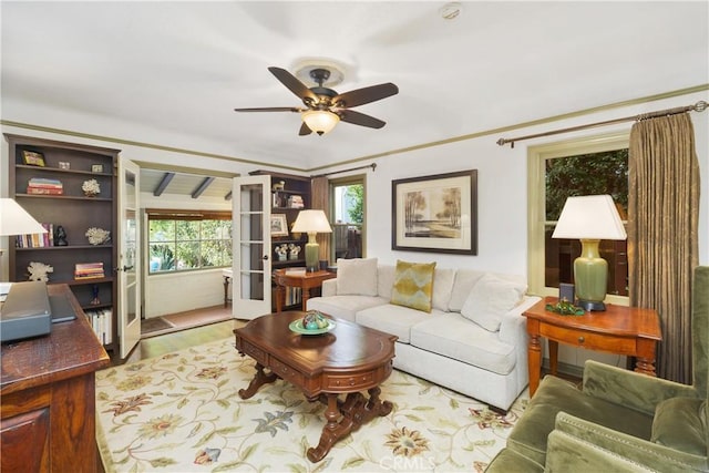 living room with light hardwood / wood-style floors, french doors, and ceiling fan