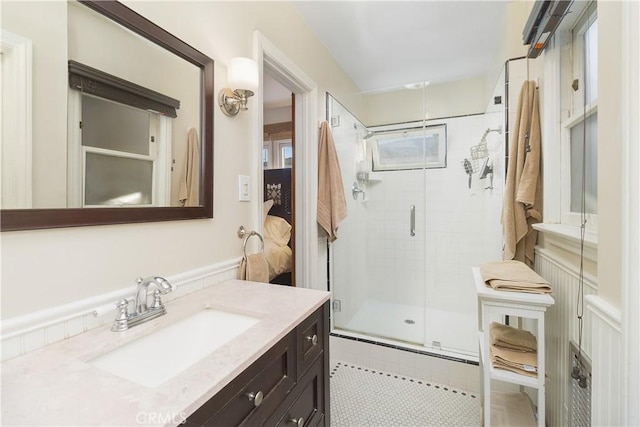 bathroom featuring vanity and a shower with shower door