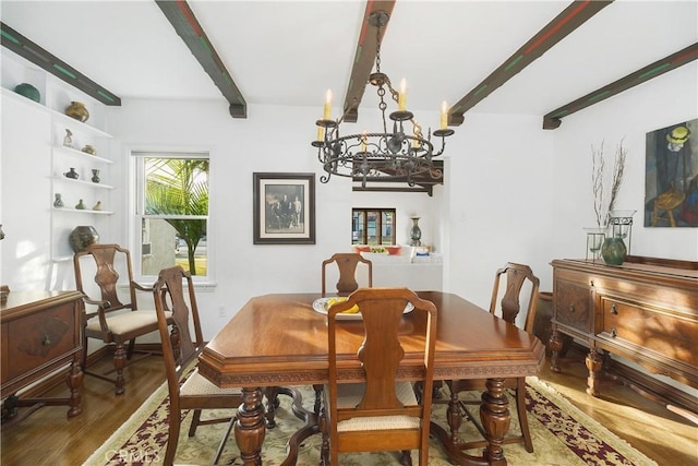 dining space with a chandelier, hardwood / wood-style floors, and beam ceiling