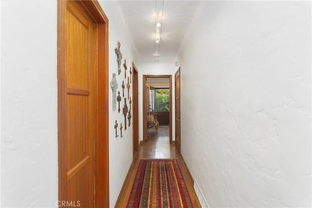 corridor with hardwood / wood-style floors