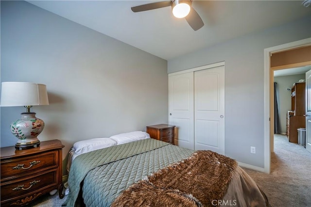 carpeted bedroom featuring a ceiling fan, baseboards, and a closet