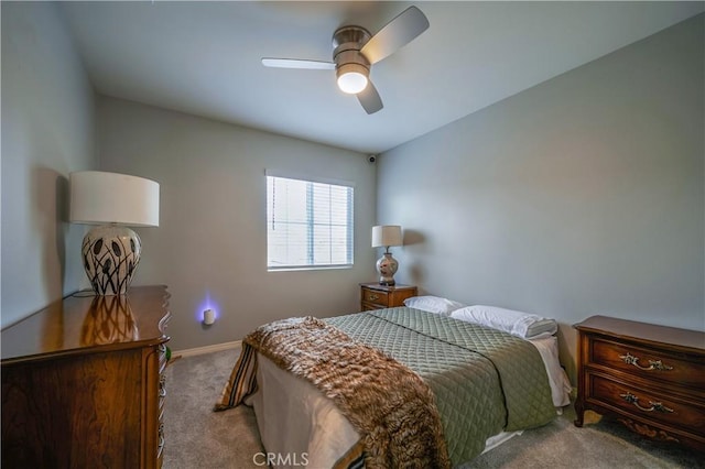 carpeted bedroom featuring ceiling fan and baseboards