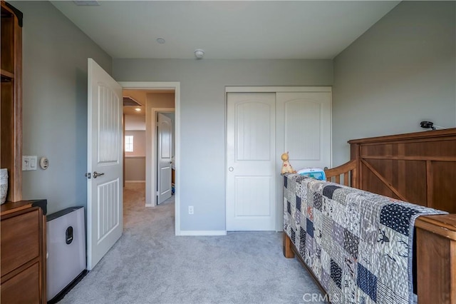 bedroom featuring a closet, carpet flooring, and baseboards