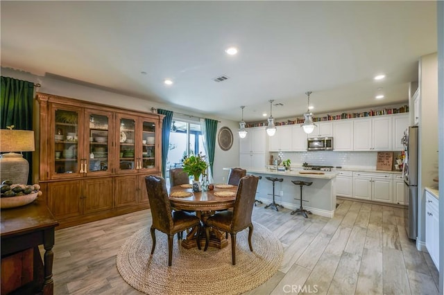 dining room featuring recessed lighting, visible vents, and light wood-style floors