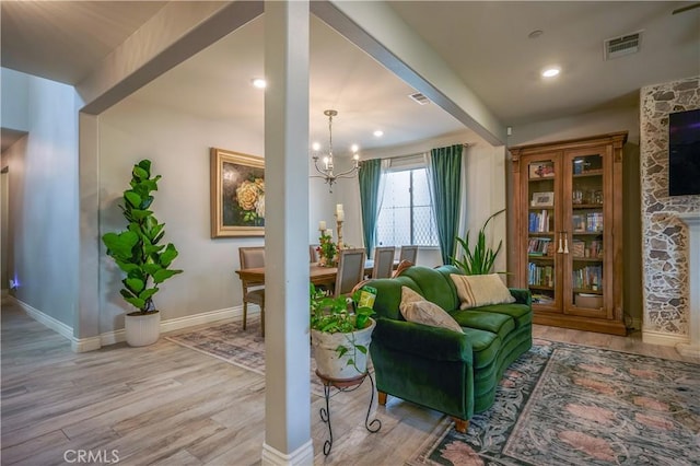 3554 Twinberry Ln, San Bernardino, CA 92407 - sitting room featuring a fireplace, wood finished floors, a chandelier, and recessed lighting