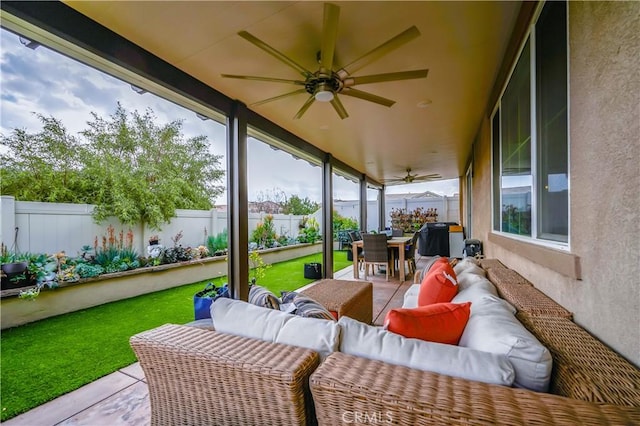 sunroom with a ceiling fan