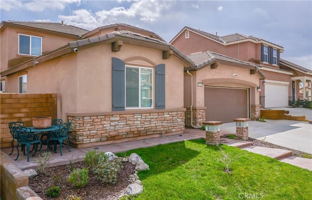 view of front facade featuring fence, stone siding, concrete driveway, stucco siding, and a front lawn