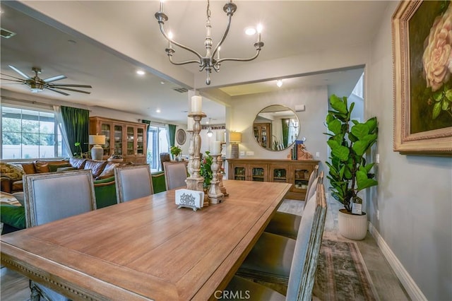 dining space featuring recessed lighting, visible vents, baseboards, and ceiling fan with notable chandelier