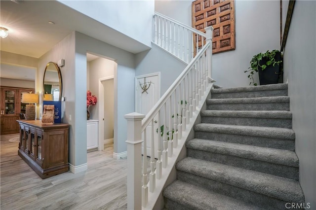 3554 Twinberry Ln, San Bernardino, CA 92407 - staircase featuring wood finished floors and baseboards