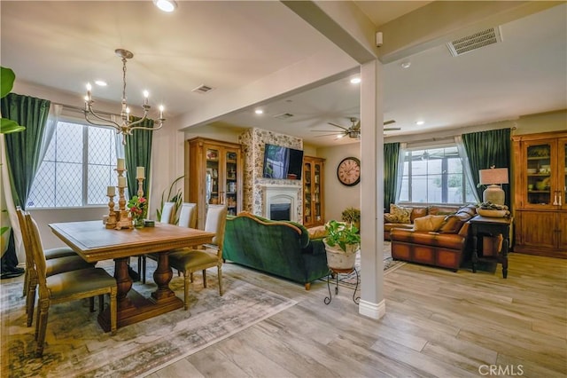 3554 Twinberry Ln, San Bernardino, CA 92407 - dining room with a chandelier, light wood-style flooring, a fireplace, recessed lighting, and a ceiling fan