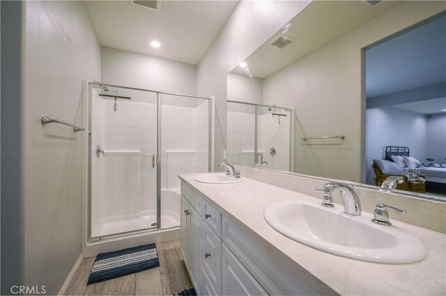 3554 Twinberry Ln, San Bernardino, CA 92407 - bathroom featuring a stall shower, wood finished floors, and double vanity
