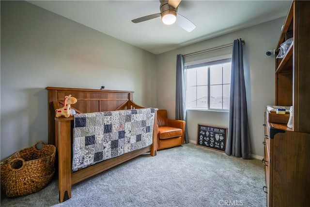 carpeted bedroom with ceiling fan and baseboards