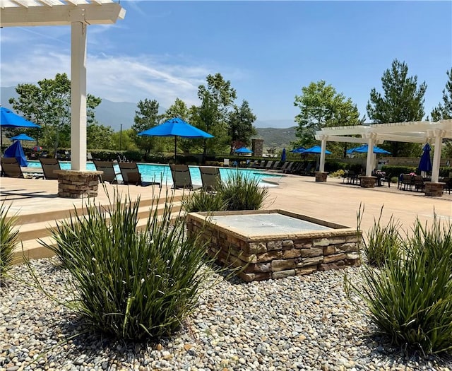 3554 Twinberry Ln, San Bernardino, CA 92407 - community pool with a mountain view, a pergola, and a patio