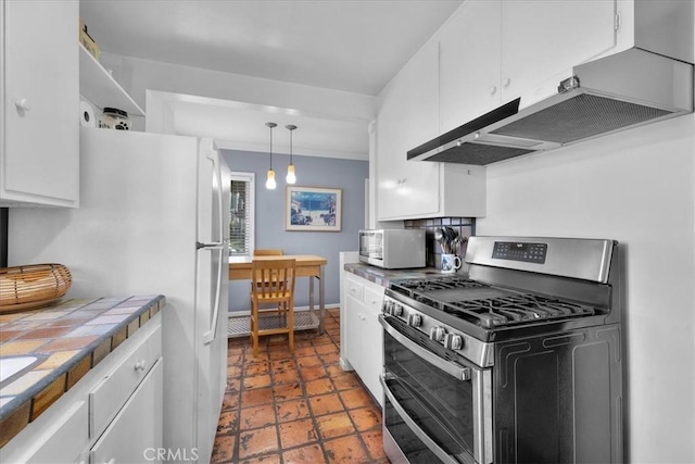 kitchen featuring double oven range, white cabinets, decorative light fixtures, tile countertops, and white fridge