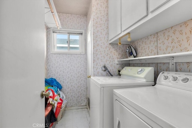 laundry area featuring independent washer and dryer and cabinets