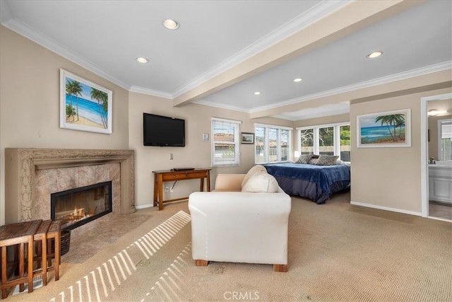 bedroom with crown molding, light carpet, and a fireplace