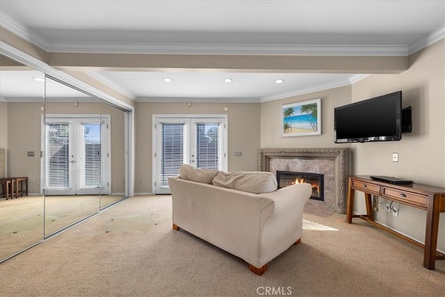 living room with ornamental molding, light carpet, a high end fireplace, and french doors