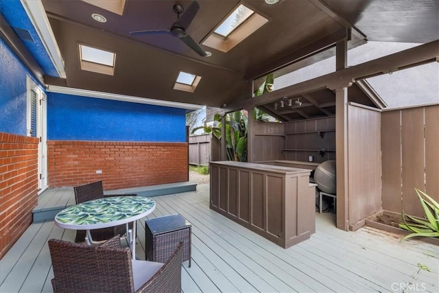 wooden terrace featuring ceiling fan