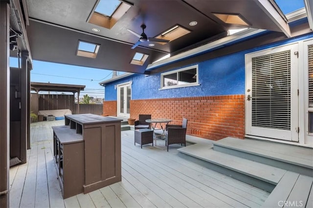 deck with an outdoor living space and ceiling fan