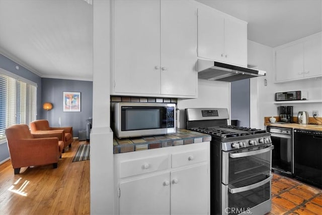 kitchen with white cabinetry, crown molding, tile countertops, light wood-type flooring, and stainless steel appliances