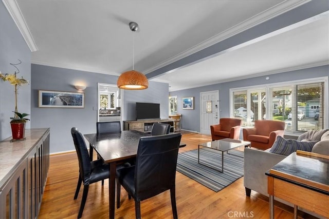 dining area with crown molding and light wood-type flooring