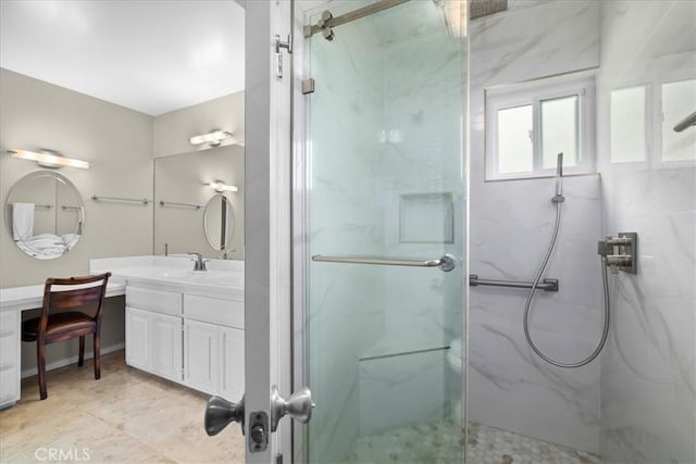 bathroom featuring vanity and a shower with door