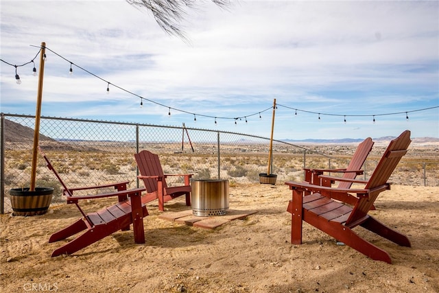 view of jungle gym with a mountain view and fence