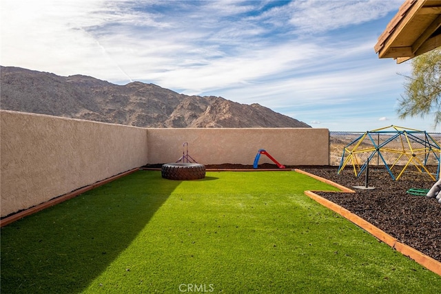 view of yard with a mountain view and a playground