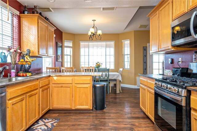 kitchen with a sink, backsplash, appliances with stainless steel finishes, and dark wood-style flooring