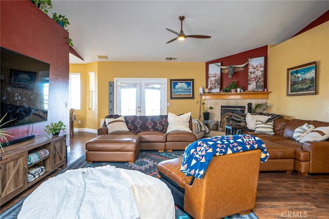 living room with french doors, visible vents, wood finished floors, and a fireplace