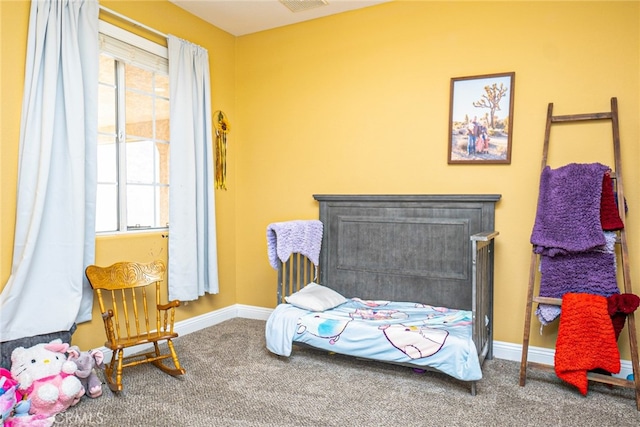 bedroom featuring baseboards and carpet