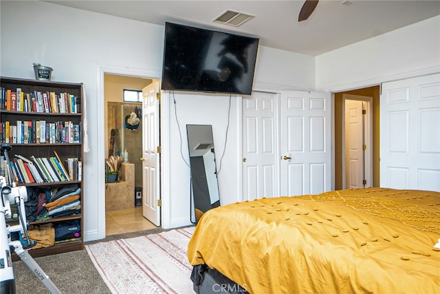 bedroom featuring visible vents and ensuite bath