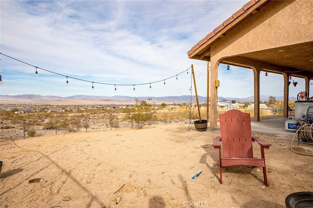 view of yard featuring a mountain view and fence