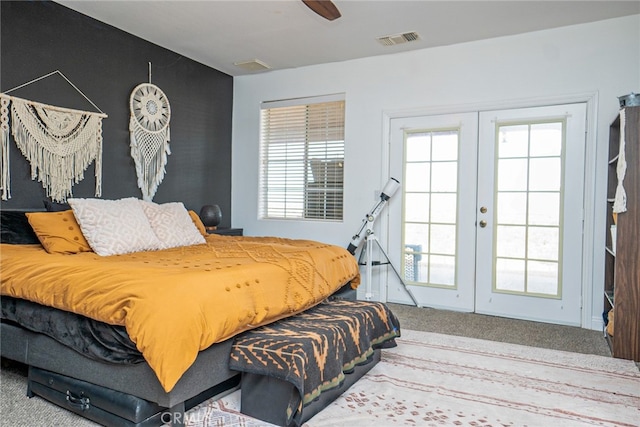 carpeted bedroom with visible vents, french doors, and ceiling fan