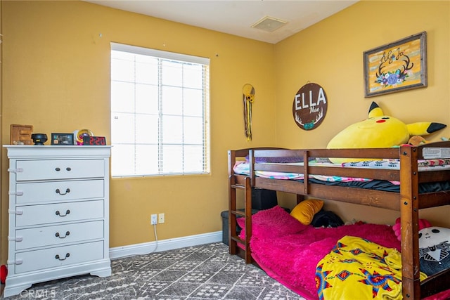 bedroom with multiple windows, baseboards, and visible vents