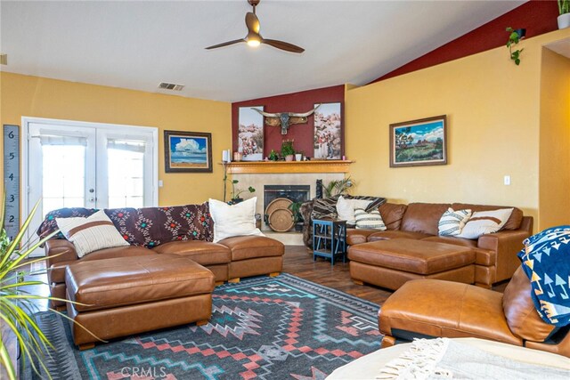 74384 Rocky Rd Unit 29, Palms, CA 92277 - living area with french doors, a ceiling fan, wood finished floors, vaulted ceiling, and a tile fireplace